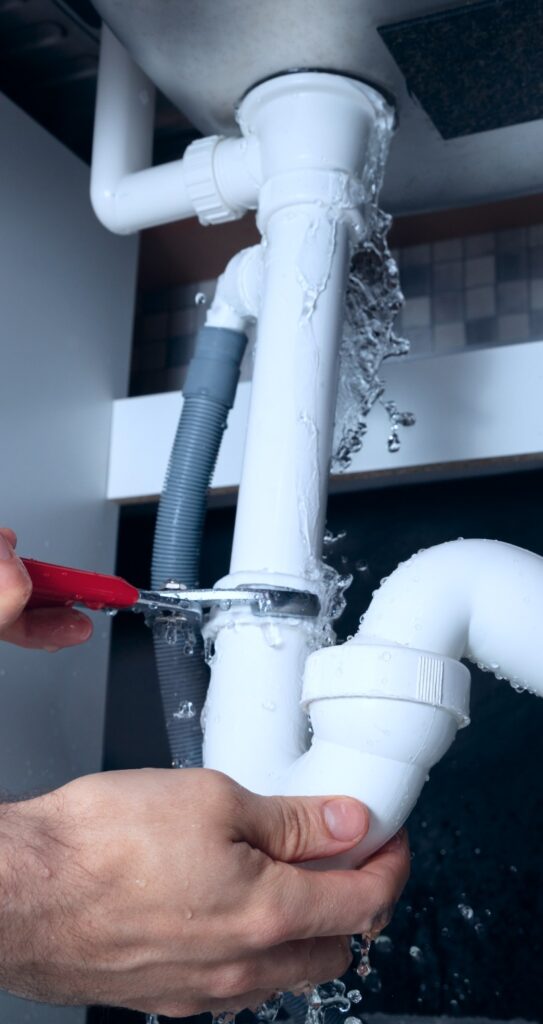 Closeup Of Male Plumber Fixing White Sink Pipe With Adjustable Wrench brick township nj